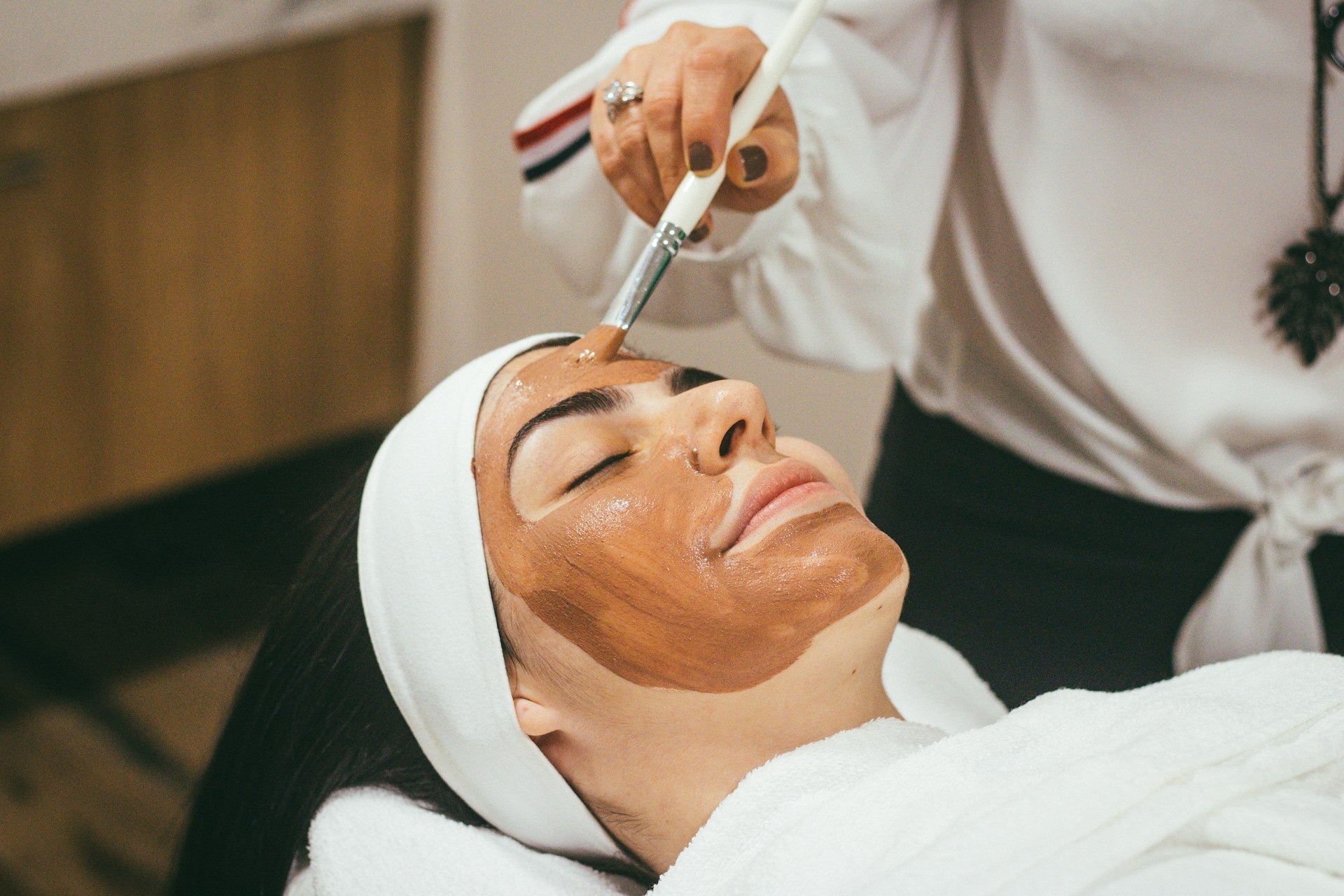Woman relaxing during a med spa facial treatment